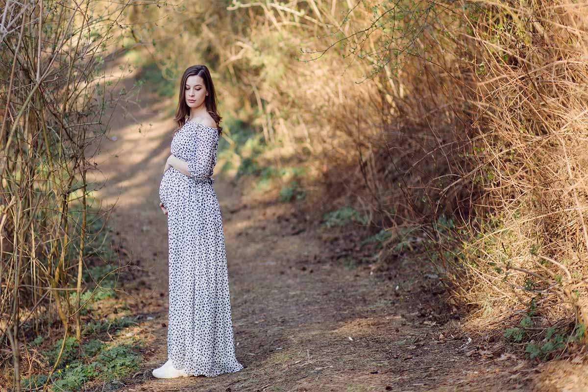 Schwangere Frau im Wald beim spazieren gehen - Babybauchfotografie mit dem Mazelle Photography Fotostudio® - Schwangerschaftsfotografie - Schwangere Frau in der Natur